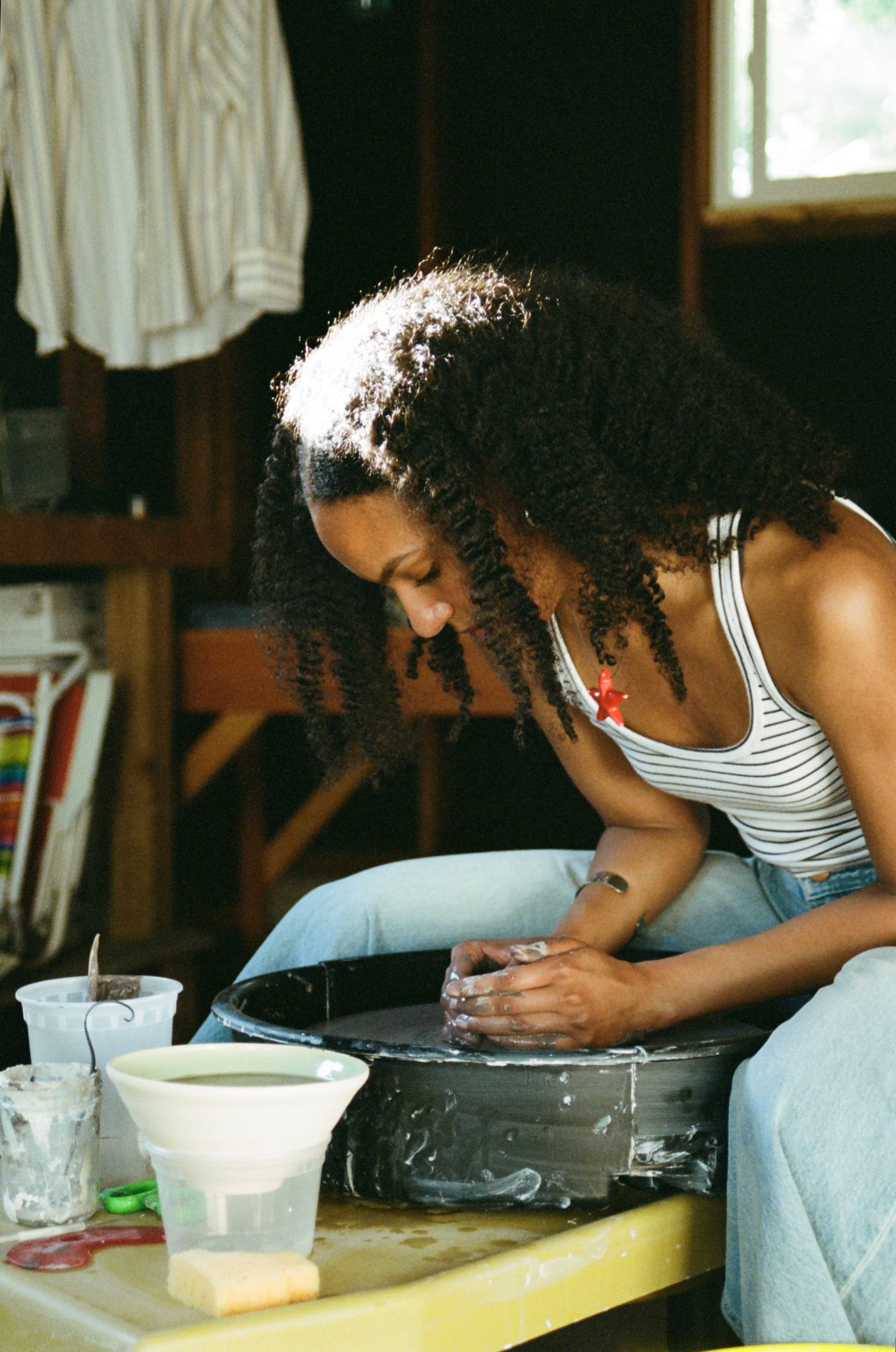 Potter shaping clay on a spinning wheel